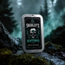 A rectangular metal tin of Skully's Heartstopper solid cologne stands upright on a mossy, rocky surface with a misty forest background. The tin has a brushed silver metal border and a black label featuring a skull illustration with green and white details.