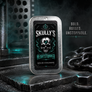 A rectangular metal tin of Skully's Heartstopper solid cologne stands on a dark industrial surface. The tin has a brushed silver border and a black label featuring a skull with a green heart and teal smoke effects.
