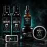 A beard grooming set from Skully's Heartstopper, including two bottles of beard wash and beard conditioner, a dropper bottle of beard oil, a jar of beard balm, and a tin of beard balm, all featuring black and green skull labels on a dark, smoky background.